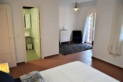 a bedroom with a bed and a dresser in a room at Costa Ballena Casa, pie playa y golf in Costa Ballena