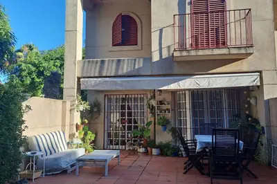 a patio with chairs and a table in front of a building at Costa Ballena Casa, pie playa y golf in Costa Ballena