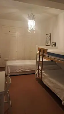 a room with two bunk beds and a chandelier at Costa Ballena Casa, pie playa y golf in Costa Ballena