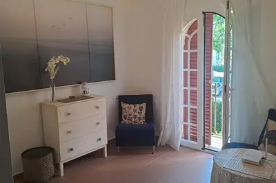 a bedroom with a dresser and a chair and a drawer at Costa Ballena Casa, pie playa y golf in Costa Ballena