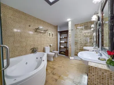 a bathroom with a tub and a sink and a toilet at Hotel Argantonio in Cádiz