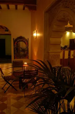 a room with chairs and a table and a mirror at Hotel Argantonio in Cádiz