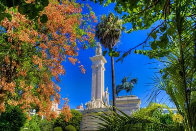 a statue in a park with trees at Hotel Argantonio in Cádiz