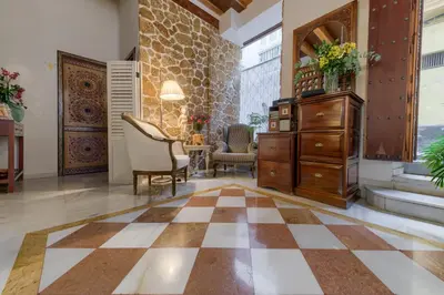 a living room with a checkered floor at Hotel Argantonio in Cádiz