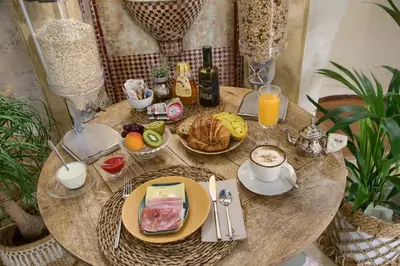a table with breakfast foods and drinks on it at Hotel Argantonio in Cádiz