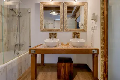 a bathroom with two sinks and a shower at Hotel Argantonio in Cádiz