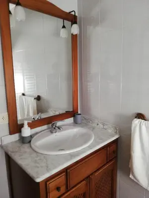 a bathroom with a sink and a mirror at El piso de Amelia in Sanlúcar de Barrameda