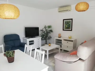 a living room with a couch and a table at El piso de Amelia in Sanlúcar de Barrameda