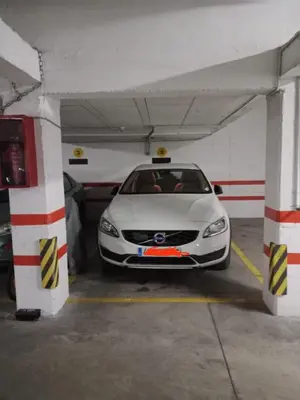 a white car parked in a parking garage at El piso de Amelia in Sanlúcar de Barrameda