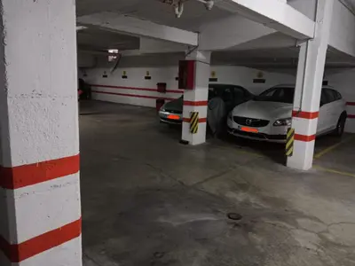 a parking garage with two cars parked in it at El piso de Amelia in Sanlúcar de Barrameda
