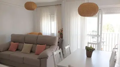 a living room with a couch and a table at El piso de Amelia in Sanlúcar de Barrameda