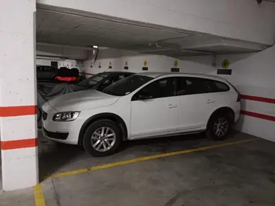a white car parked in a parking garage at El piso de Amelia in Sanlúcar de Barrameda