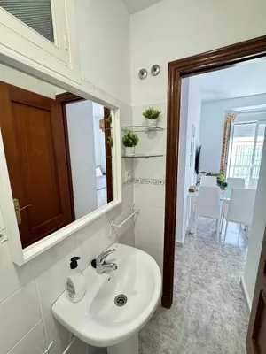 a bathroom with a sink and a mirror at Cabildo 3 in Sanlúcar de Barrameda