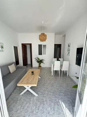 a living room with a couch and a table at Cabildo 3 in Sanlúcar de Barrameda