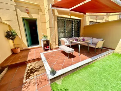 a patio with a table and chairs on a lawn at GATU PREMIUM Villa Sal Marina 