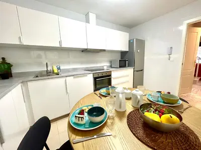 a kitchen with a wooden table with a bowl of fruit on it at GATU PREMIUM Villa Sal Marina 