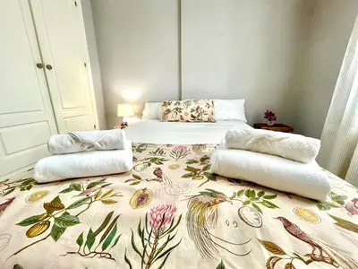 a bedroom with a bed with a floral blanket at GATU PREMIUM Villa Sal Marina 