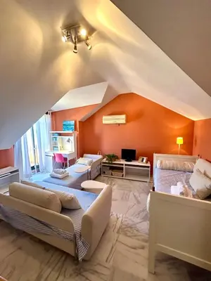 a bedroom with two beds and an orange wall at GATU PREMIUM Villa Sal Marina 