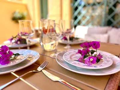 a table with three plates with purple flowers on them at GATU PREMIUM Villa Sal Marina 