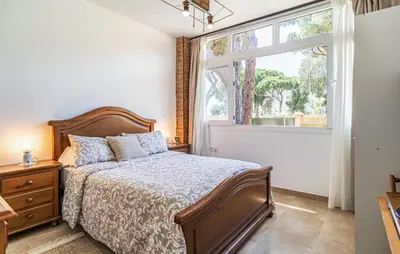 a bedroom with a bed and a window at Nice Home In Chiclana De La Fronter in Novo Sancti Petri