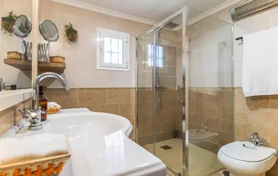 a bathroom with a shower and a sink and a toilet at Nice Home In Chiclana De La Fronter in Novo Sancti Petri