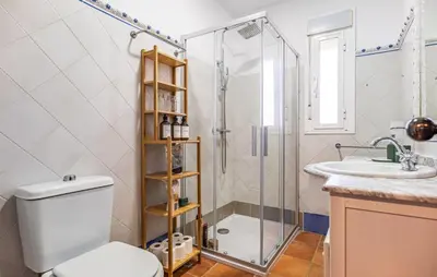 a bathroom with a shower and a toilet and a sink at Nice Home In Chiclana De La Fronter in Novo Sancti Petri