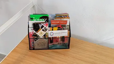 a pile of books sitting on top of a shelf at Apartamentos Turísticos Antonio Parra in Jerez de la Frontera