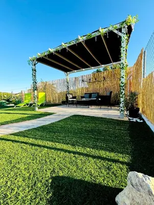 a pavilion with a picnic table in a garden at Casa Rural El Pequeño Oasis in Arcos de la Frontera