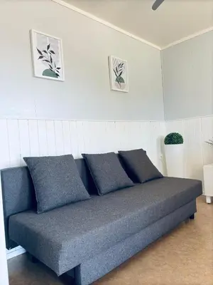 a couch with four pillows in a room at Casa Rural El Pequeño Oasis in Arcos de la Frontera
