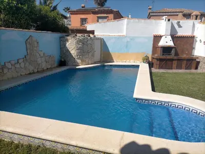 a swimming pool in the backyard of a house at Villa Mesana in Chiclana de la Frontera