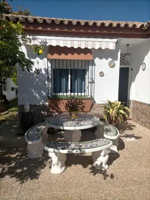 a bathroom with a white shower curtain and a toilet at Villa Mesana in Chiclana de la Frontera