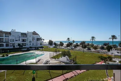 a view of the beach from the balcony of a apartment at Pinomar, estupendo apartamento en primera línea de playa in Chiclana de la Frontera