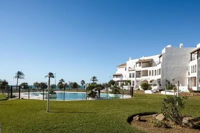 a view of a resort with a pool and buildings at Pinomar, estupendo apartamento en primera línea de playa in Chiclana de la Frontera