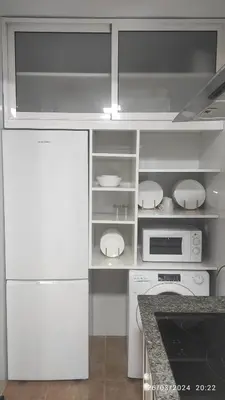 a kitchen with white appliances and a counter top at Ático en Chipiona in Chipiona