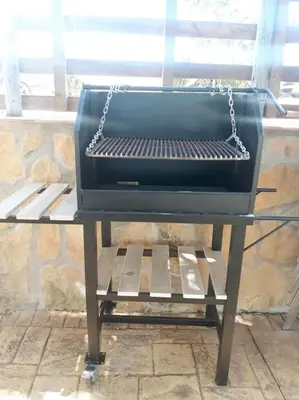 a grill sitting on a bench next to a window at Casa Rural El Almendrillo in Arcos de la Frontera