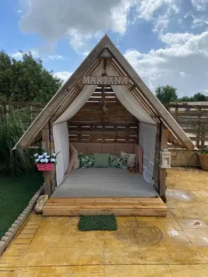 a large wooden bed in a small house at Casa Rural El Almendrillo in Arcos de la Frontera
