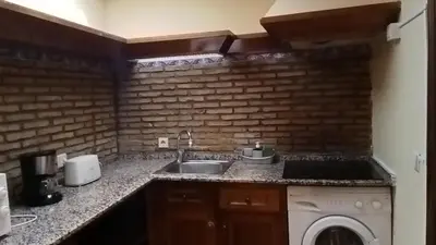 a kitchen with a sink and a washing machine at Apartamentos Jasmund - Bungalow 87 in San Fernando