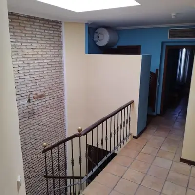 a hallway with a staircase and a brick wall at Apartamentos Jasmund - Bungalow 87 in San Fernando