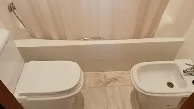 a bathroom with a white toilet and a sink at Apartamentos Jasmund - Bungalow 87 in San Fernando