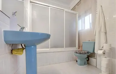 a bathroom with a blue sink and a toilet at 2 Bedroom Stunning Apartment In Rota in Rota