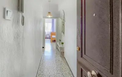 a hallway with a door and a room with a table at 2 Bedroom Stunning Apartment In Rota in Rota