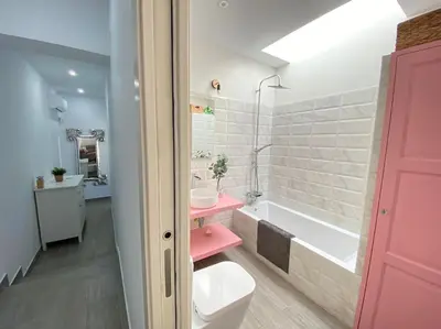 a bathroom with a toilet and a sink and a tub at Chalet Benamejí in Sanlúcar de Barrameda