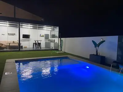 a large blue swimming pool in a room at Chalet Benamejí in Sanlúcar de Barrameda
