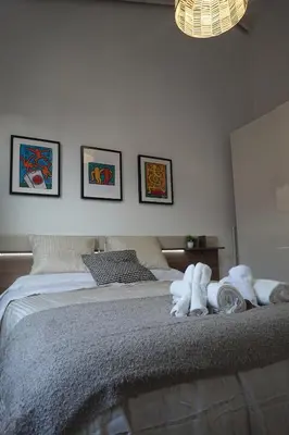 a bedroom with a bed with stuffed animals on it at Apartamento Casa Dalí in Jerez de la Frontera
