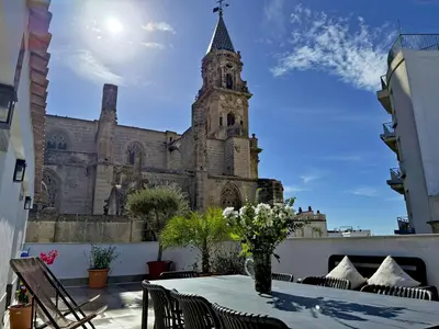 a church with a table and chairs in front of it at Apartamento San Miguel - Ole Solutions in Jerez de la Frontera