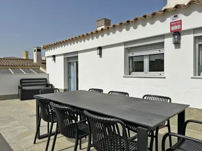 a black table and chairs on a patio at Apartamento San Miguel - Ole Solutions in Jerez de la Frontera