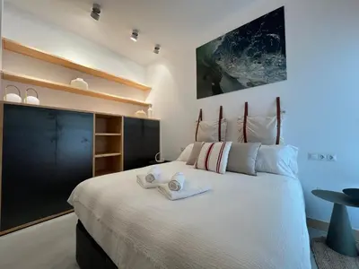 a bedroom with a large bed with towels on it at Atico Torre Tavira Ascensor Grupo AC Gestion in Cádiz