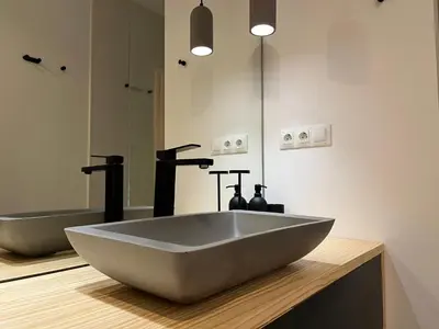 a bathroom with a large white sink and a mirror at Atico Torre Tavira Ascensor Grupo AC Gestion in Cádiz