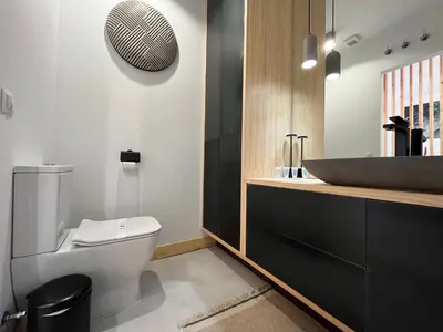 a bathroom with a white toilet and a sink at Atico Torre Tavira Ascensor Grupo AC Gestion in Cádiz