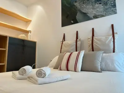 a bedroom with a bed with towels on it at Atico Torre Tavira Ascensor Grupo AC Gestion in Cádiz